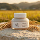 Angle : niveau des yeux  Beauty of Joseon Ground Rice and Honey Glow Mask displayed on natural stone among golden rice stalks, soft sunrise lighting, traditional Korean countryside inspiration, luxury skincare product photography, realistic atmosphere, premium beauty campaign, shallow depth of field. (gemini-3-pro-image-preview)